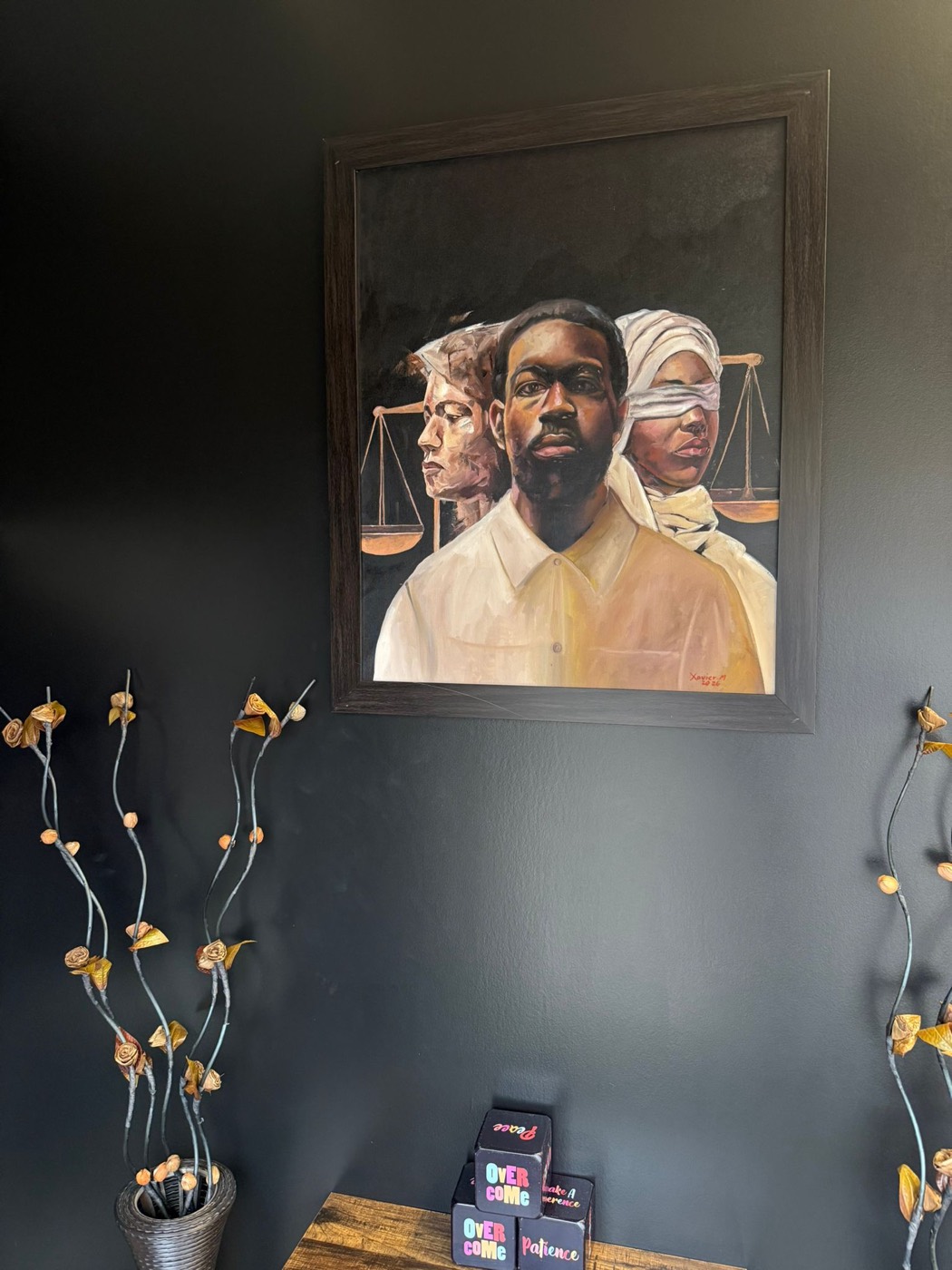Justice-themed artwork on display at the Kwilu Law Chamber office